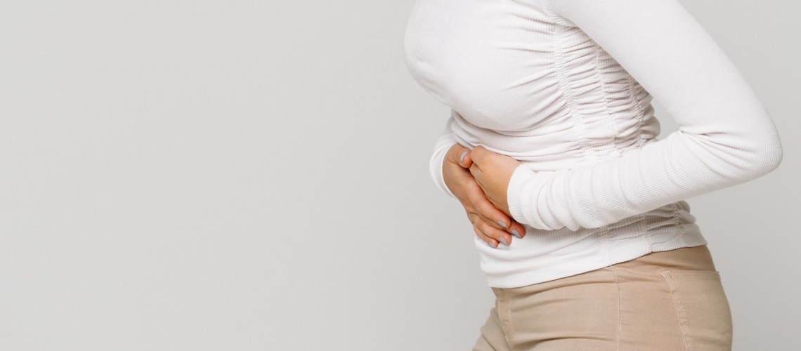 Woman suffering from stomach pain, abdominal pain, cramps
